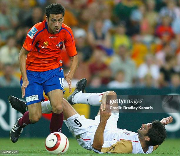 Alex Brosque of the Roar gets past the defence of Ned Zelic of the Jets during the A-League match between the Queensland Roar and the Newcastle Jets...