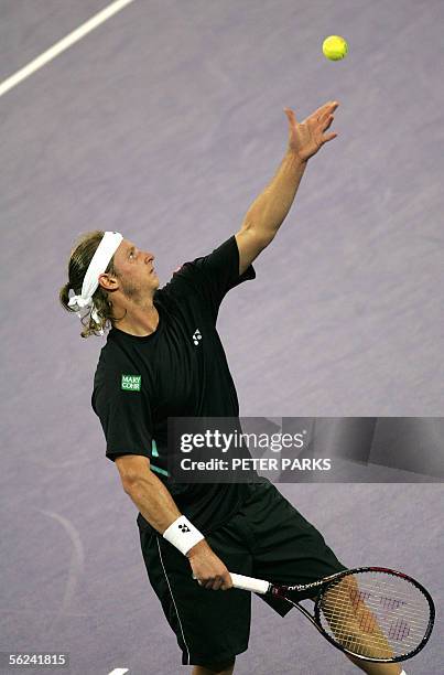 David Nalbandian of Argentina serves to Swiss world number one Roger Federer in the final of the Tennis Masters Cup in Shanghai 20 November 2005....