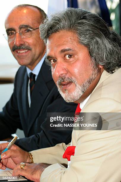 Indian airline Kingfisher owner Vijya Mallya is seen near ATR CEO Filippo Bagnato during a press conference to announce a 350 million US dollar deal...