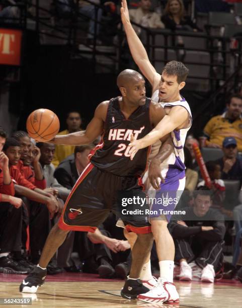 Gary Payton of the Miami Heat looks for an open man to pass against Jose Calderon of the Toronto Raptors on November 20, 2005 at the Air Canada...