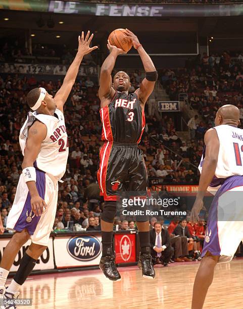 Dwyane Wade of the Miami Heat shoots over Morris Peterson of the Toronto Raptors on November 20, 2005 at the Air Canada Centre in Toronto, Canada....