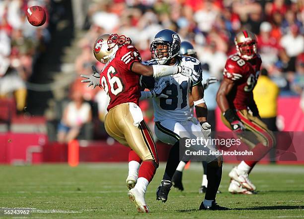 Peter Warrick of the Seattle Seahawks fumbles a reception against Bruce Thornton of the San Francisco 49ers during the NFL game on November 20, 2005...