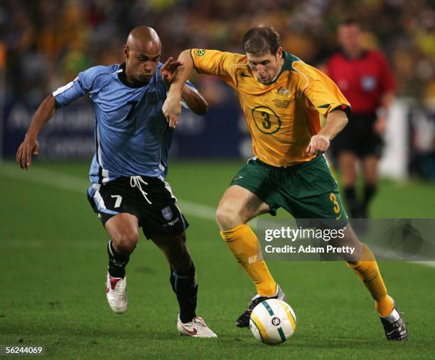 Gustavo Varela of Uruguay and Scott Chipperfield of the Socceroos in action during the second leg of the 2006 FIFA World Cup qualifying match between...