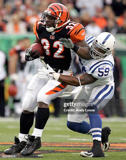 Cato June of the Indianapolis Colts tackles Rudi Johnson of the Cincinnati Bengals during the NFL game at Paul Brown Stadium on November 20, 2005 in...