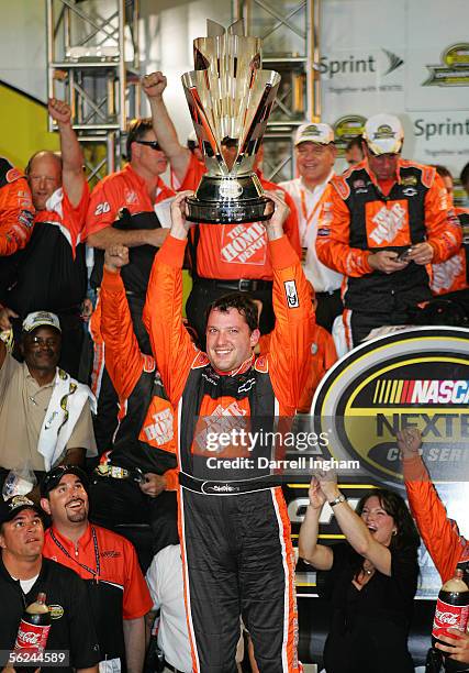 Tony Stewart, driver of the Home Depot Chevrolet, celebrates winning the championship with his crew after the NASCAR Nextel Cup Ford 400 on November...