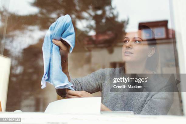 woman cleaning glass of house window - fönsterputsare bildbanksfoton och bilder