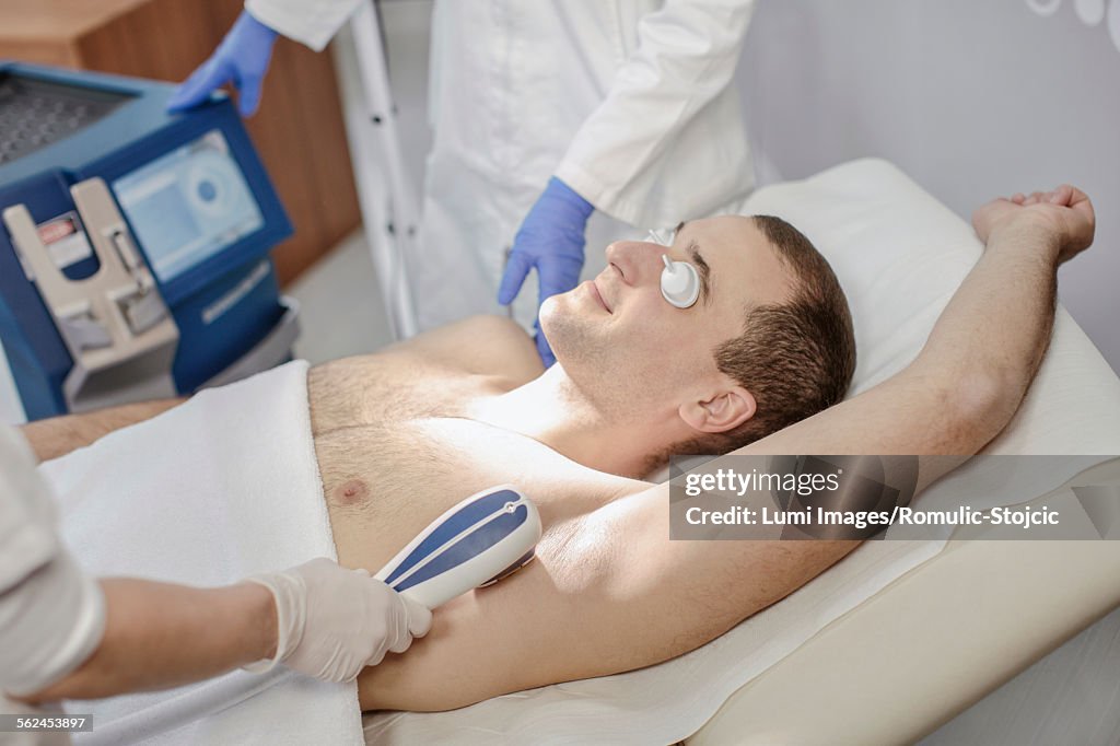 Young man receiving laser treatment