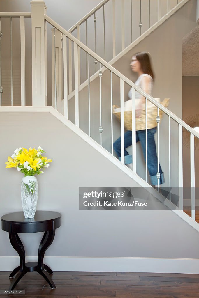 Woman carrying basket of laundry