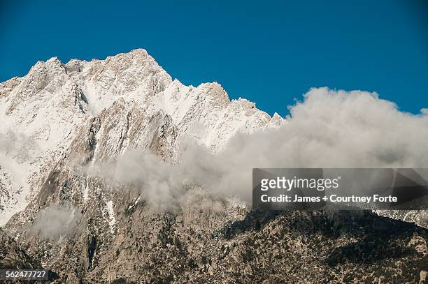 early morning clouds move across the face of mount whitney, eastern sierras, california. - berg mount whitney stock-fotos und bilder