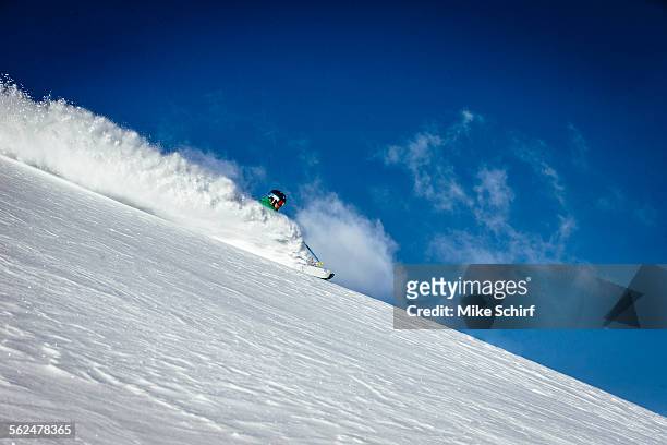 a man skiing fresh snow on a sunny day. alta, utah - alta utah stock pictures, royalty-free photos & images