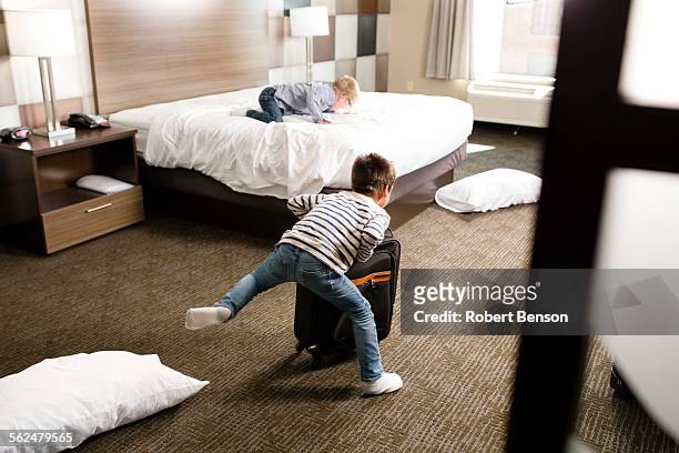 two boys play in a motel room. - kids hotel bildbanksfoton och bilder