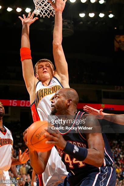 Marc Jackson of the New Jersey Nets goes for the pump fake against Andris Biedrins of the Golden State Warriors on November 21, 2005 at the Arena in...