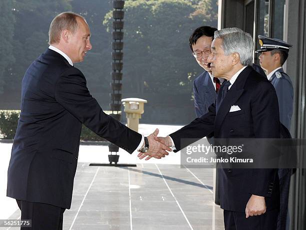 Russian President Vladimir Putin shakes hands with Japanese Emperor Akihito upon his arrival at the Imperial Palace on November 22, 2005 in Tokyo,...