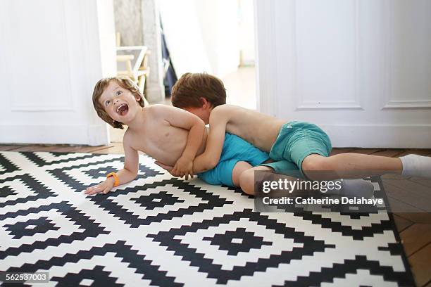 2 brothers playing together - rough housing stock pictures, royalty-free photos & images