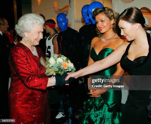 Queen Elizabeth II meets singers Charlotte Church and Katherine Jenkins as The Blue Man Group look on, backstage following the Royal Variety...