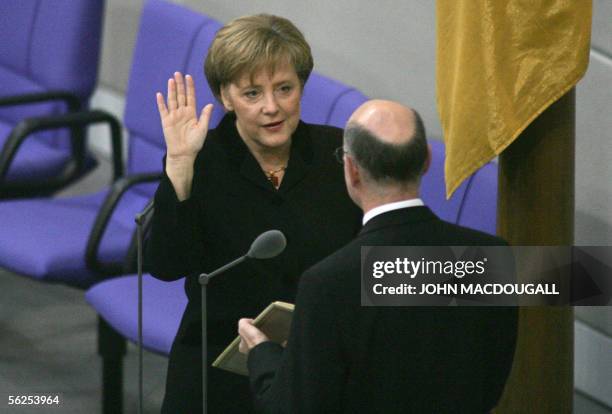 Christian Democratic Union leader Angela Merkel is sworn in by Parliament speaker Norbert Lammert to become Germany's new chancellor during a session...