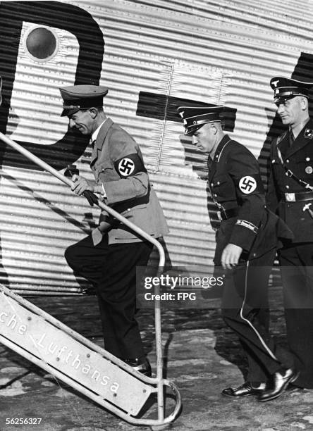 German journalist and Nazi Minister of Propaganda Joseph Goebbels walks up a stairway to get on an airplane at Tempelhof airport for his flight at...