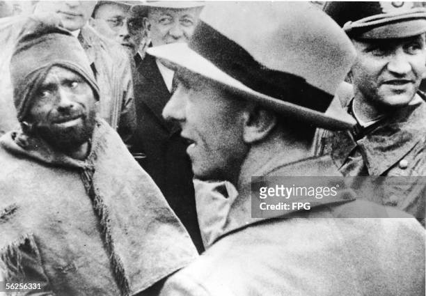 German journalist and Nazi Minister of Propaganda Joseph Goebbels stands before a Russian prisoner in a crowd of German officers and officials during...