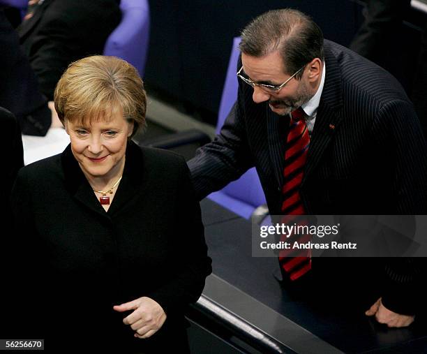 German Chancellor Angela Merkel of the Christian Democrats looks on while Social Democrats party chairman Matthias Platzeck talks to her at a...