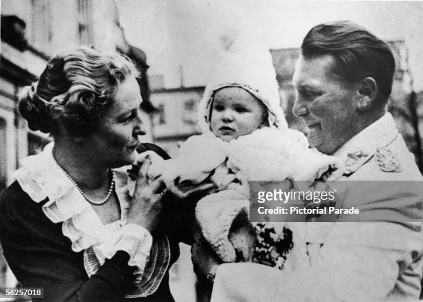 Luftwaffe commander, Gestapo founder, and Nazi leader Field Marshall Hermann Goering and his second wife actress Emmy hold aloft their daughter Edda...