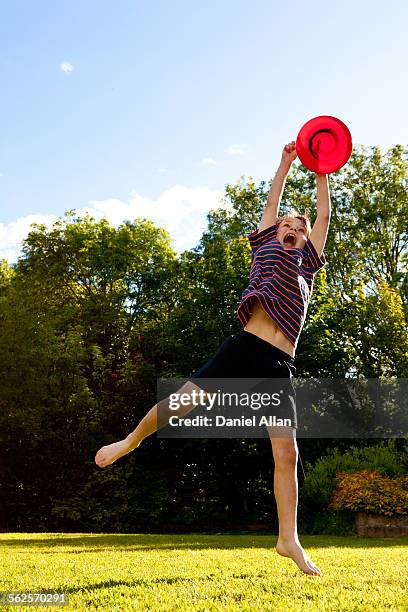 catching frisbee - flying disc stock pictures, royalty-free photos & images