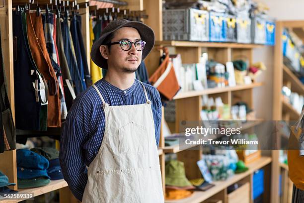 a japanese man in his 30's stands in his shop. - s thirtysomething stock pictures, royalty-free photos & images