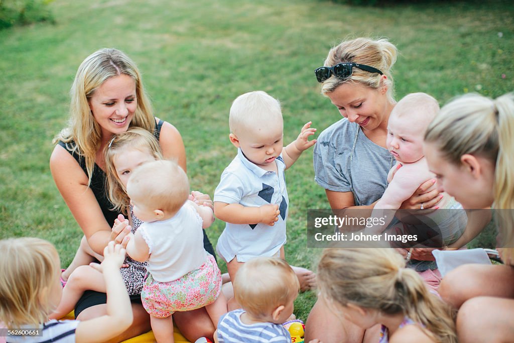 Women with children on grass