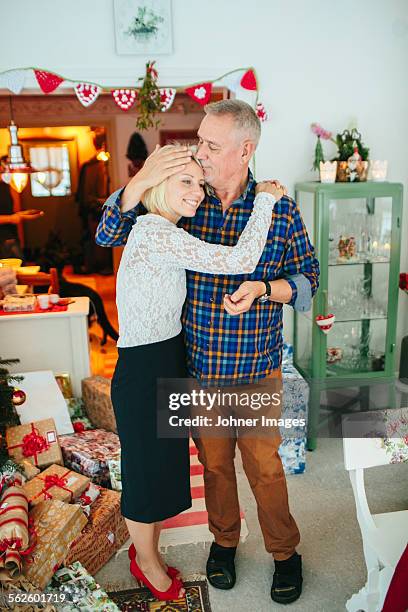 father and adult daughter at christmas - old man woman christmas stock pictures, royalty-free photos & images