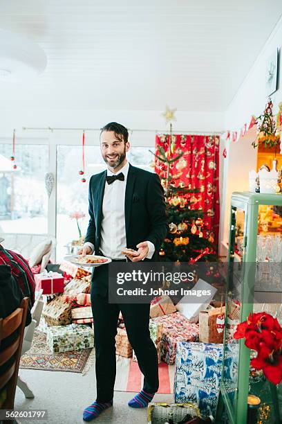 smiling man at christmas dinner - johner christmas foto e immagini stock