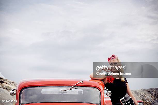 woman wearing retro clothes near vintage car - rockabilly stock pictures, royalty-free photos & images