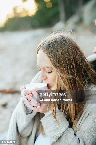 young woman having drink on beach - hot blonde woman fotografías e imágenes de stock