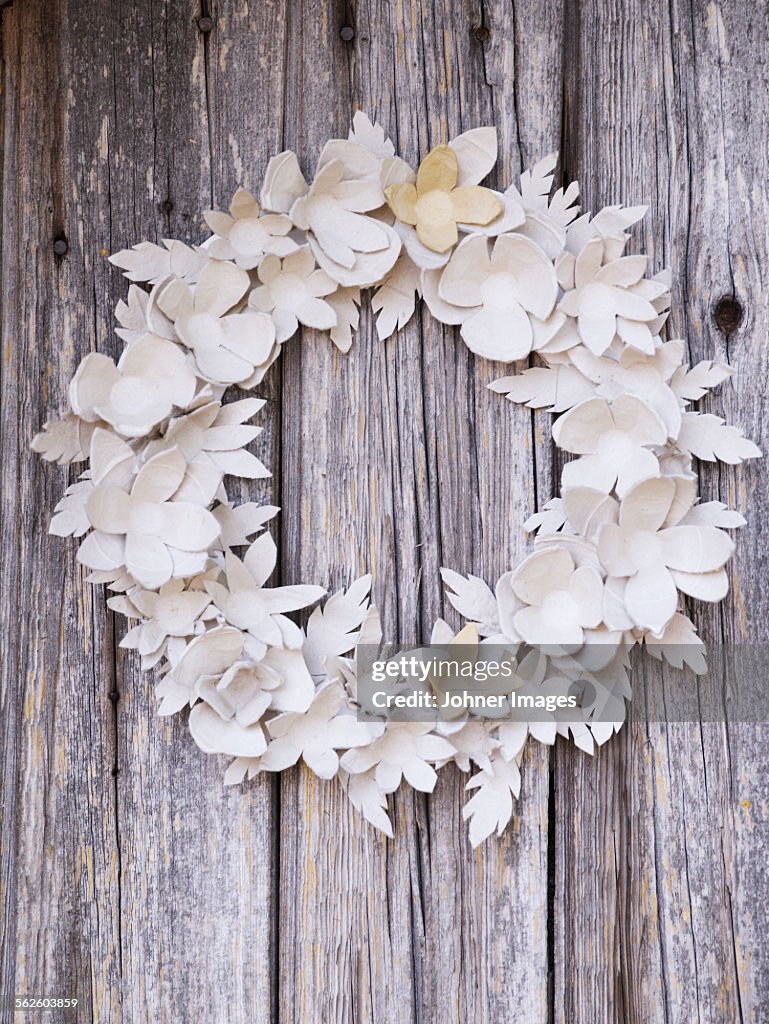 Paper wreath on wooden wall