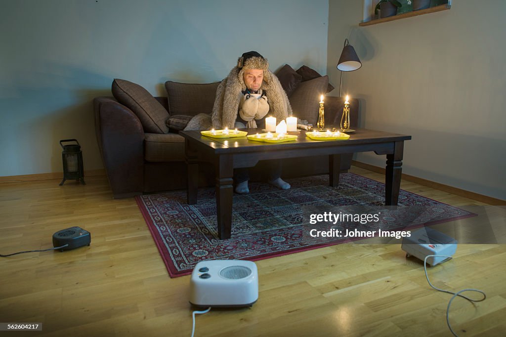 Man sitting in cold living room