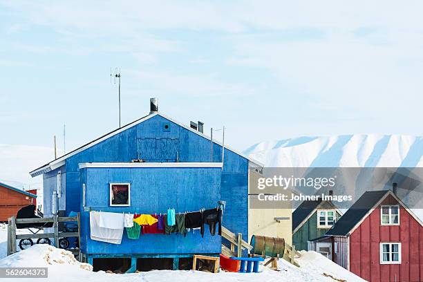 buildings in remote landscape - qaanaaq stock pictures, royalty-free photos & images