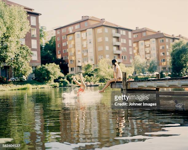 couple having a swim - bathing jetty stock pictures, royalty-free photos & images