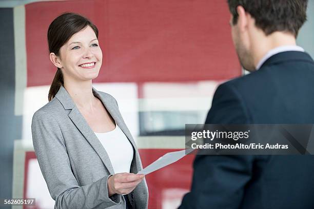 hotel reception staff delivering fax to guest - reception of france stock pictures, royalty-free photos & images