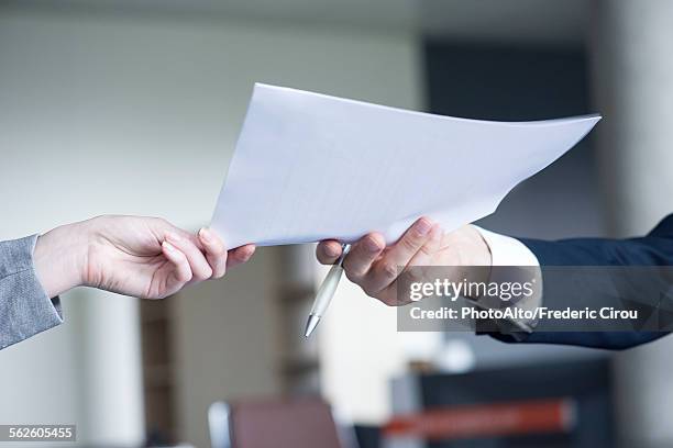 businessman handing document to colleague, cropped - hand receiving stock pictures, royalty-free photos & images