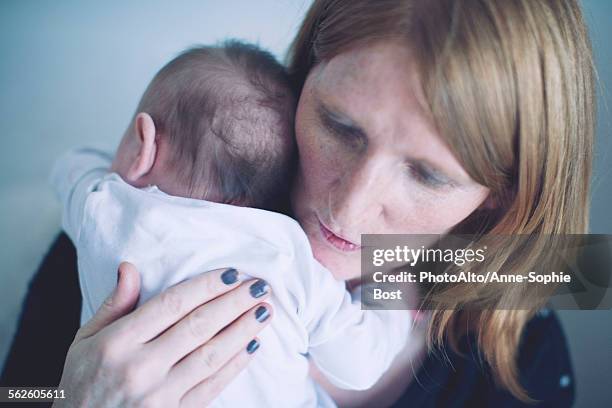 mother comforting newborn baby - anne sophie mutter stock-fotos und bilder