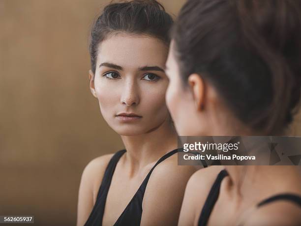 portrait of beautiful woman - reflection in mirror stock-fotos und bilder