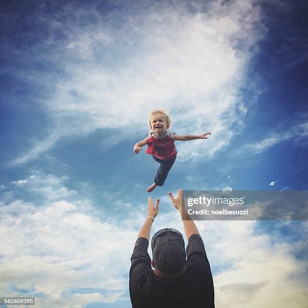 Father throwing his son in the air