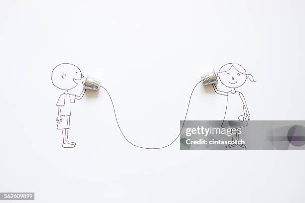 conceptual boy and girl talking with tin can phones - thimble stock pictures, royalty-free photos & images