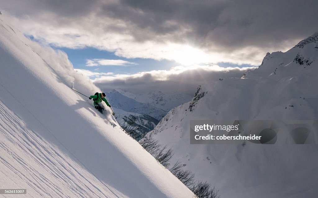 Man Powder Skiing at sunset, Lech, Austria