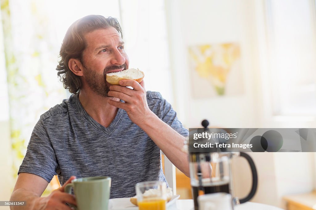 Mature man eating breakfast