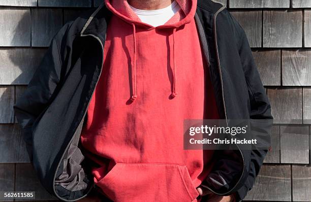 man wearing red hooded shirt - sweatshirt stockfoto's en -beelden