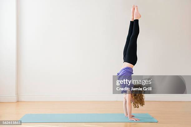 girl (10-11) doing handstand - girl yoga stock pictures, royalty-free photos & images