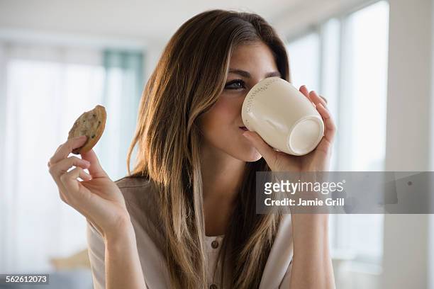 woman with cookie and coffee - east region sweet stock pictures, royalty-free photos & images