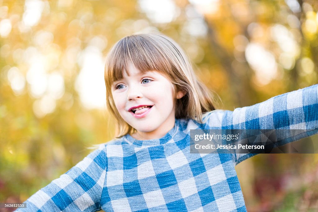 Young girl (4-5) with arms outstretched