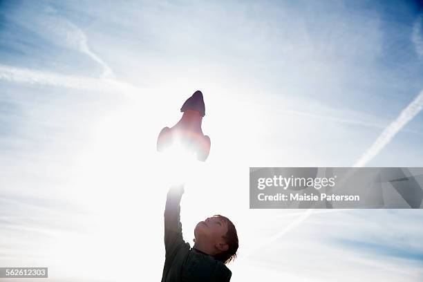 boy (6-7) playing with toy rocket - model rocket launch stock pictures, royalty-free photos & images