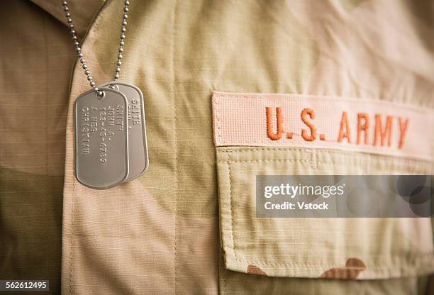 soldier wearing shirt and dog tags - military uniform close up stock pictures, royalty-free photos & images