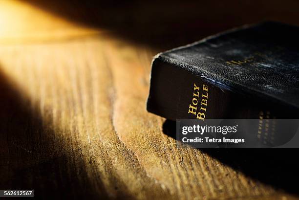 close up of bible on table - bibel stock-fotos und bilder